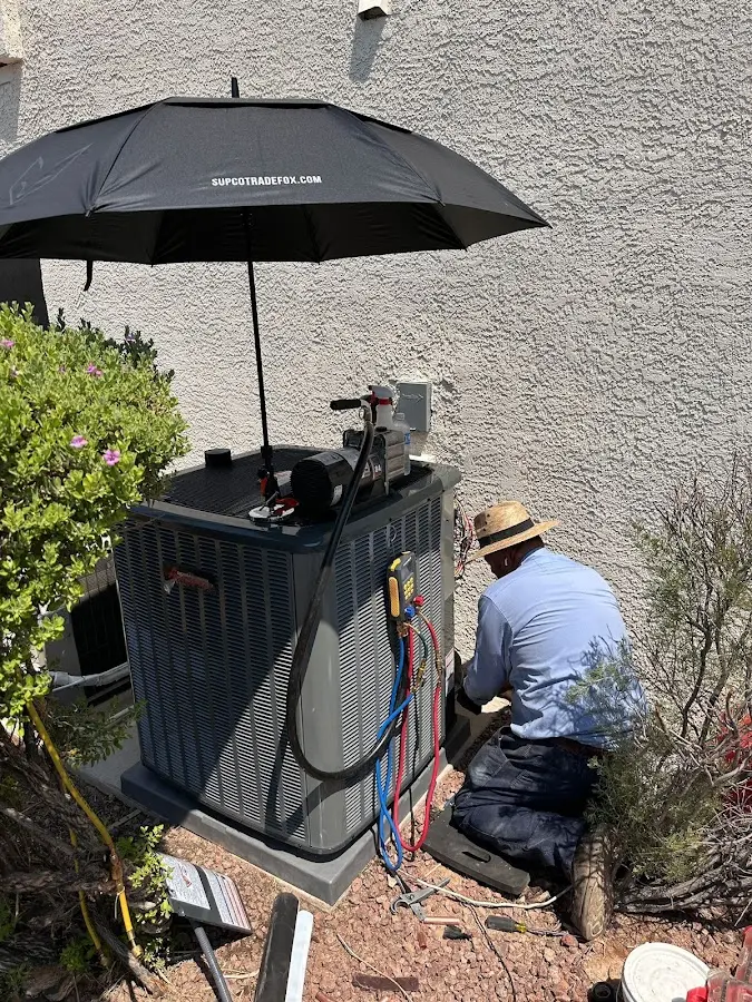HVAC technician performing outdoor AC maintenance in Halfway